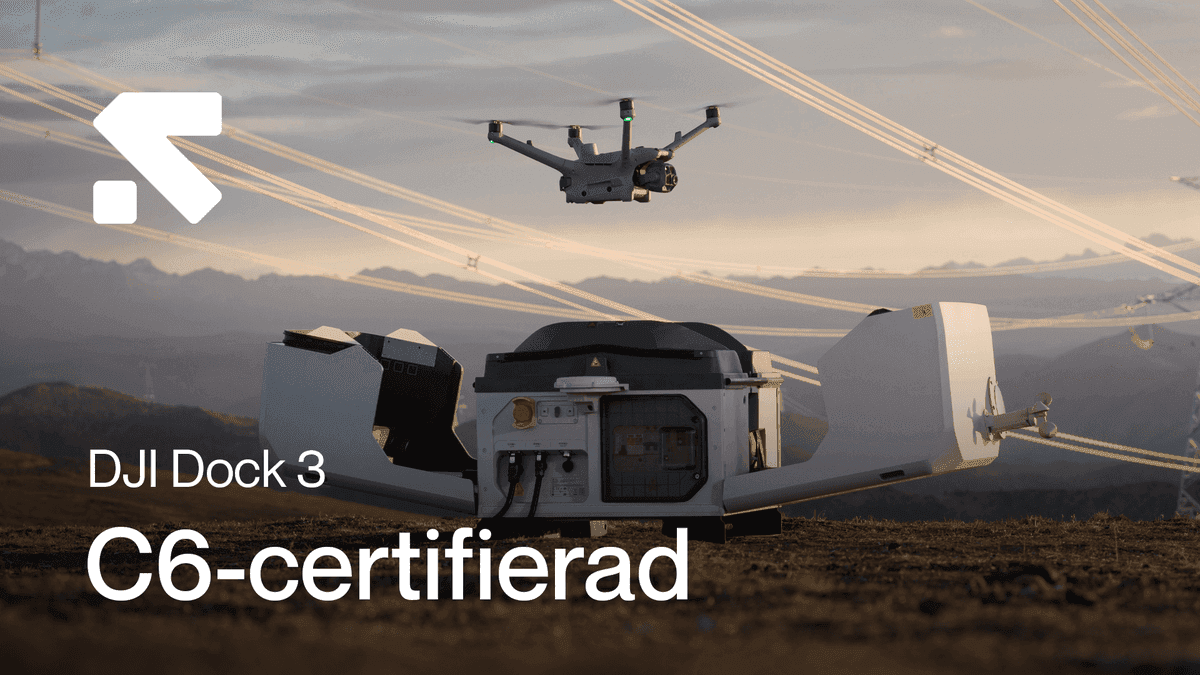 En drönare lyfter från en DJI Dock 3-station i ett öppet landskap, med kraftledningar i bakgrunden.