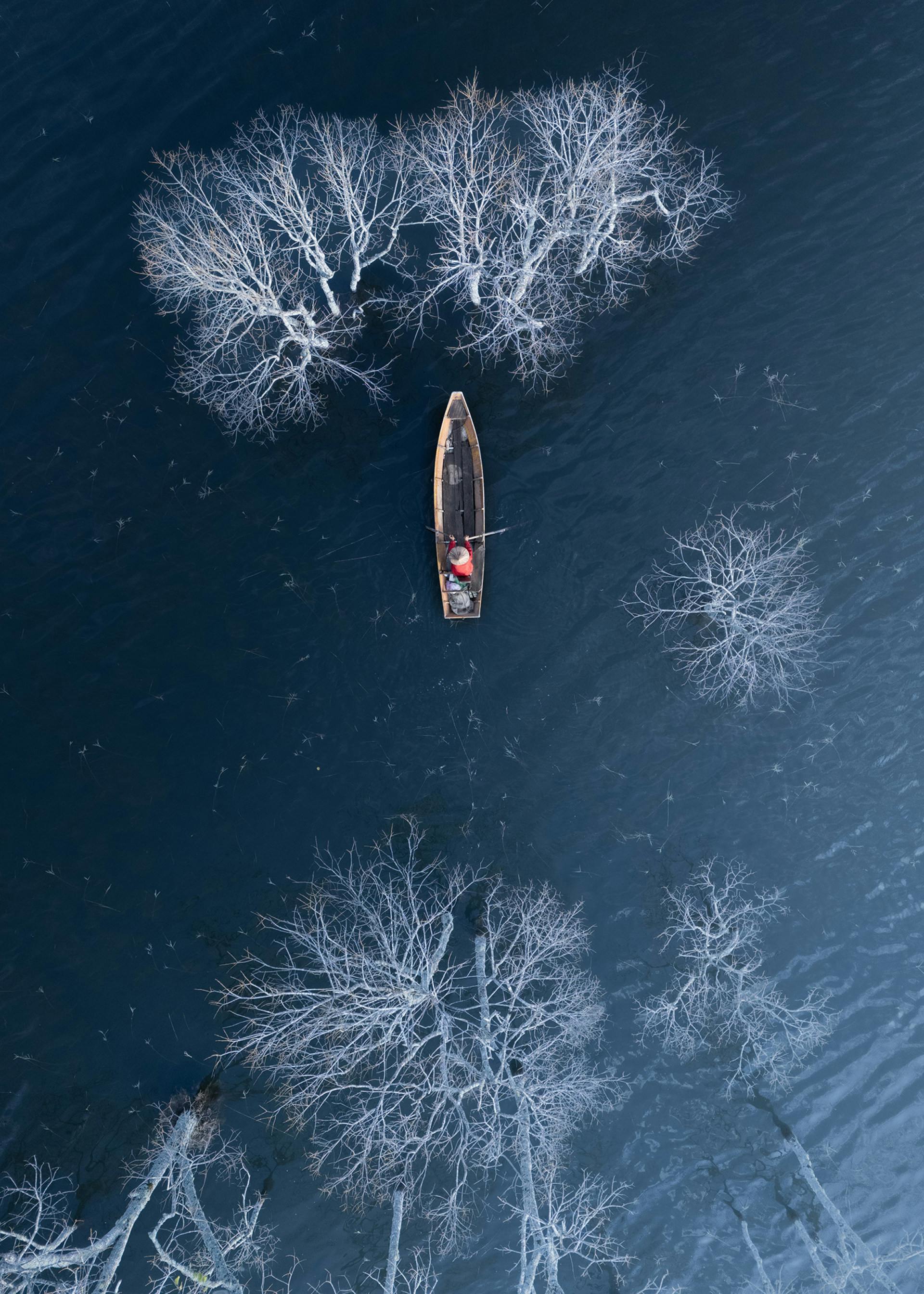 Winter on the lake with old men on lonely boat